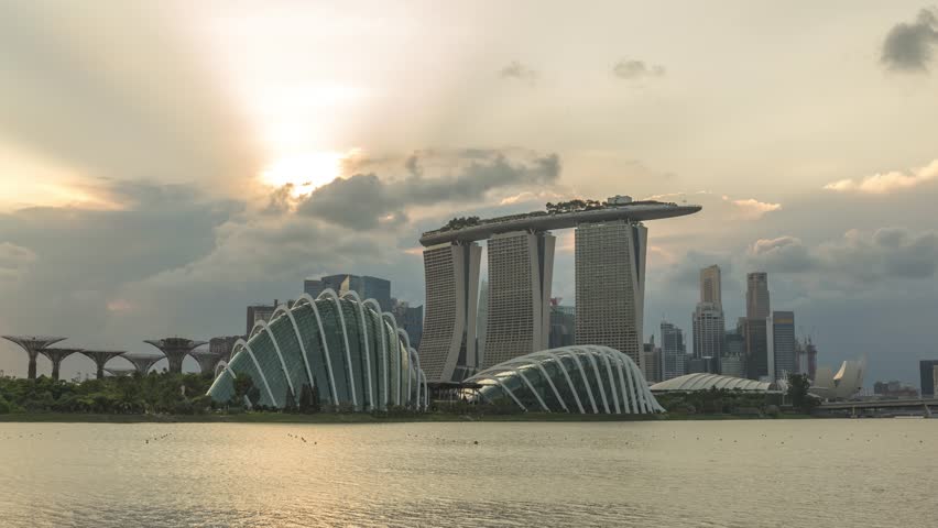 Singapore time lapse city skyline day to night sunset at Marina Bay waterfront business district