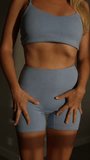 Close-up of a young fit woman in seamless activewear, showing off toned abs and perfect fit of the sports outfit. Confident posture and golden light highlight body definition - Powered by Shutterstock - Get 15% off with code: PIKWIZARD15