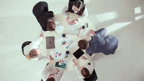 Top-down view of diverse team working with charts and sticky notes during creative meeting. Concept of innovation, teamwork, productivity, and inspired communication in corporate environment. - Powered by Shutterstock - Get 15% off with code: PIKWIZARD15