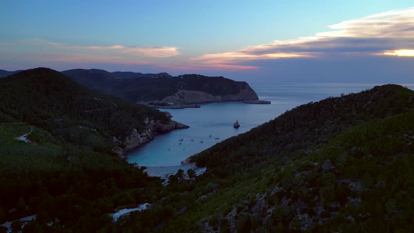 Ibiza Cala Benirras bay coastline at sunset. Perfect aerial view flight drone