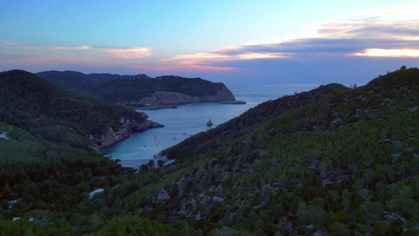 Ibiza Cala Benirras bay coastline at sunset. Great aerial view flight drone
