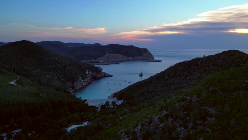 Ibiza Cala Benirras bay coastline at sunset. Unique aerial view flight drone