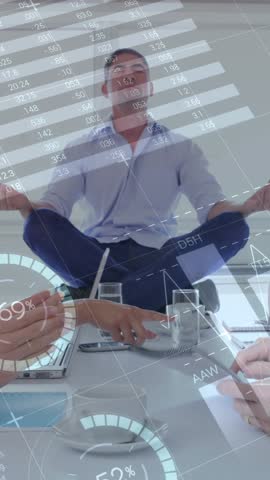 Digital composite of a Caucasian man meditating on top of the table while diverse colleagues debate and graphs move in the screen 4k