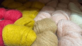 Colorful skeins of wool yarn in various shades, perfect for knitting projects or crafting video - Powered by Shutterstock - Get 15% off with code: PIKWIZARD15