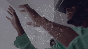 Tech expert wearing VR headset pinching holographic globe enabling interactive data visualization. Futuristic, innovation, digital, immersive, workspace, technology, connectivity - Powered by Shutterstock - Get 15% off with code: PIKWIZARD15