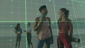Four women holding mats walking beach toward yoga session, shifting focus to foreground duo smiling. Friendship, wellness, outdoor, fitness, tranquility, diversity, leisure - Powered by Shutterstock - Get 15% off with code: PIKWIZARD15