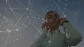 Woman fitting red earbuds and zipping jacket while activating glowing network overlay for workout. Fitness, technology, wellness, innovation, athletic, motivation, activewear - Powered by Shutterstock - Get 15% off with code: PIKWIZARD15