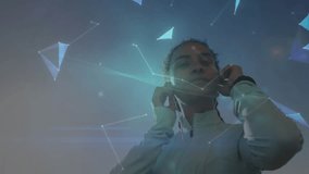 Woman securing headphones and activating holographic globe emerging for tech insight. Futuristic, digital, connectivity, immersive, innovative, technology, interface - Powered by Shutterstock - Get 15% off with code: PIKWIZARD15