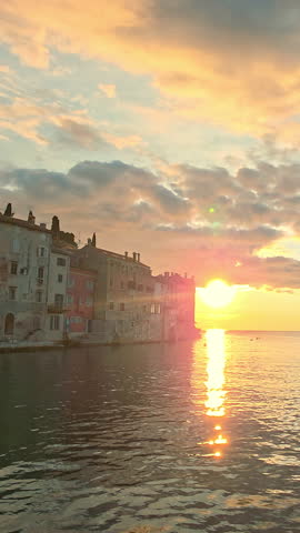 Stunning sunset view over the historic old town of Rovinj, Croatia, with famous church tower and vivid sky colors