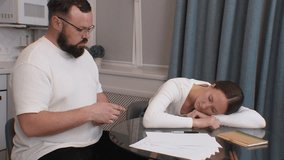 Young married couple sitting at glass kitchen table counting last remaining dollars, trying to figure out how to pay bills, woman thoughtfully holding finger on lips, man pointing at banknotes - Powered by Shutterstock - Get 15% off with code: PIKWIZARD15