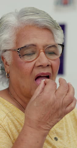 Senior woman, medicine and water at hospital for healthcare, supplements and patient recovery. Elderly person, checkup and pills with beverage, omega 3 and antibiotics for medical treatment at clinic