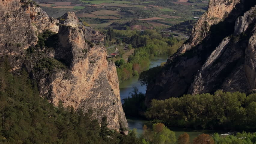 Aerial View of a River Canyon with Rock Formations and Train Tracks, Capturing the Beauty of Nature and Human Infrastructure