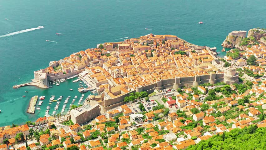 Aerial view of Dubrovnik, Croatia — showcasing the iconic Old Town with medieval walls, terracotta rooftops, and the sparkling Adriatic Sea in stunning coastal scenery.