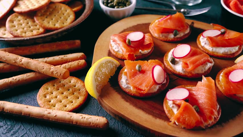 Delicious smoked salmon canapés served on crackers with cream cheese and herbs — an elegant appetizer perfect for parties, celebrations, and gourmet dining.