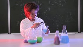 Back to school. Boy doing chemical research at desk against chalkboard with formulas indoors - Powered by Shutterstock - Get 15% off with code: PIKWIZARD15