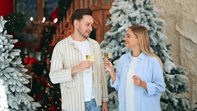 Joyful couple celebrating Christmas. Sharing happy cheers with champagne, surrounded by festive decor. Warmth and happiness radiating, creating precious holiday memories together. Feeling love - Powered by Shutterstock - Get 15% off with code: PIKWIZARD15