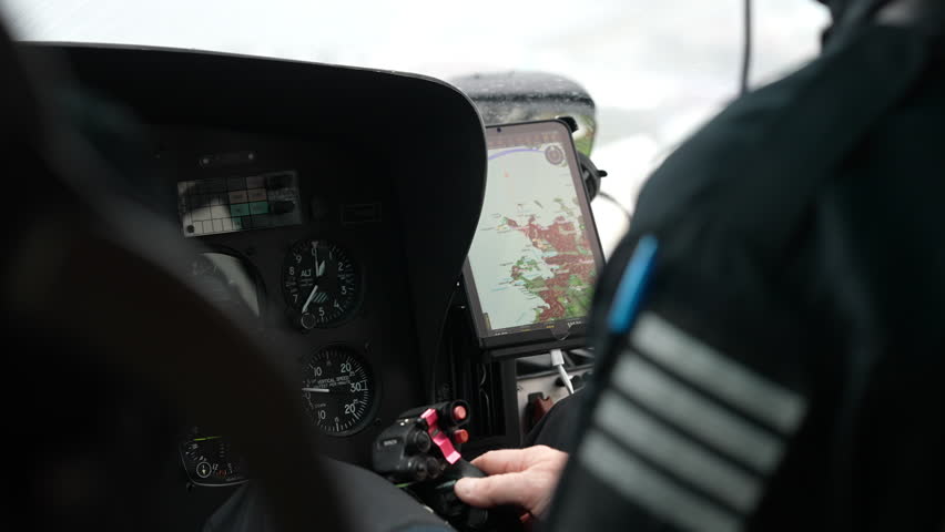 Pilot Hand on Helicopter Flight Controls with Navigation Tablet