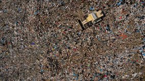 Drone view of a landfill site showing a working bulldozer among garbage piles and flying seagulls, illustrating environmental pollution and waste management. - Powered by Shutterstock - Get 15% off with code: PIKWIZARD15