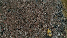 Drone view of a landfill site showing a working bulldozer among garbage piles and flying seagulls, illustrating environmental pollution and waste management. - Powered by Shutterstock - Get 15% off with code: PIKWIZARD15