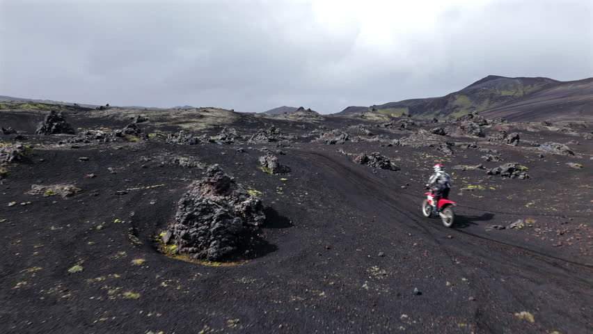 Enduro Motorcycle Rider on Volcanic Terrain