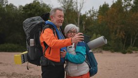 Hiking tourism adventure. Senior couple making selfie enjoying outdoor recreation hiking. Old people backpackers hikers taking photo enjoy walking hike trekking active vacation beauty of nature - Powered by Shutterstock - Get 15% off with code: PIKWIZARD15