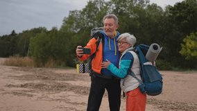 Hiking tourism adventure. Senior couple making selfie enjoying outdoor recreation hiking. Old people backpackers hikers taking photo enjoy walking hike trekking active vacation beauty of nature - Powered by Shutterstock - Get 15% off with code: PIKWIZARD15