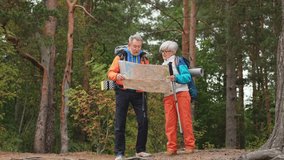 Hiking tourism. Senior couple man woman looking track in paper map enjoying hiking in forest. Happy old people backpackers hikers enjoy walking hike trekking tourism active vacation beauty of nature - Powered by Shutterstock - Get 15% off with code: PIKWIZARD15