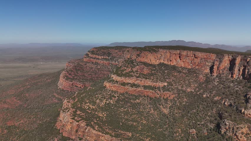 Flinders Ranges, South Australia – 4K Aerial Drone Footage of Rugged Red Cliffs, Rocky Hills, Forest, and Expansive Outback Valleys under Clear Blue Skies in Australia Inland