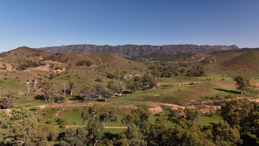 Arkaba Hill Lookout, Flinders Ranges, South Australia – 4K Aerial Drone Footage of Rugged Red Cliffs, Rocky Hills, Forest, and Expansive Outback Valleys under Clear Blue Skies in Australia Inland