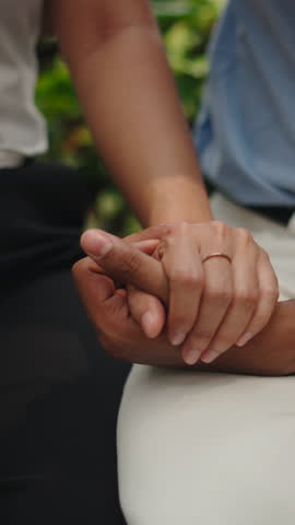 Close up of loving couple holding hands