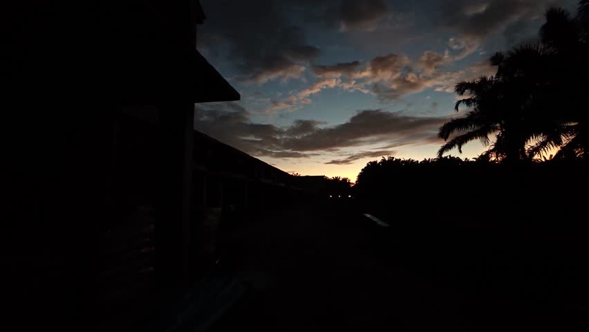 Looking from the farm toward the early morning dawn sky outshirt the housing area. 