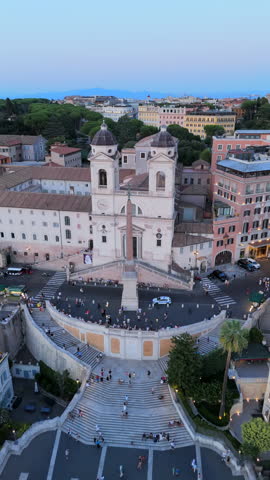 Breathtaking aerial shots of iconic Spanish Steps in Rome Italy, capturing the stunning beauty of sunset while showcasing vibrant urban life and its energetic atmosphere, perfect travel destination