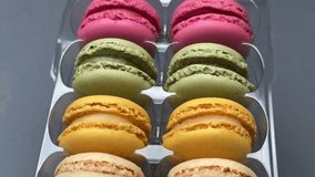 A close-up video of assorted colorful macarons neatly arranged in a box, showcasing their delicate textures, pastel tones and appetizing presentation suitable for dessert or bakery themes. - Powered by Shutterstock - Get 15% off with code: PIKWIZARD15