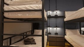 a hostel room with double-storey black beds with white bedding  - Powered by Shutterstock - Get 15% off with code: PIKWIZARD15