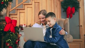 Mother and child enjoy festive Christmas video call, sharing happy moments. Joyful family connection, celebrating holidays with technology. Embracing togetherness during special season. - Powered by Shutterstock - Get 15% off with code: PIKWIZARD15