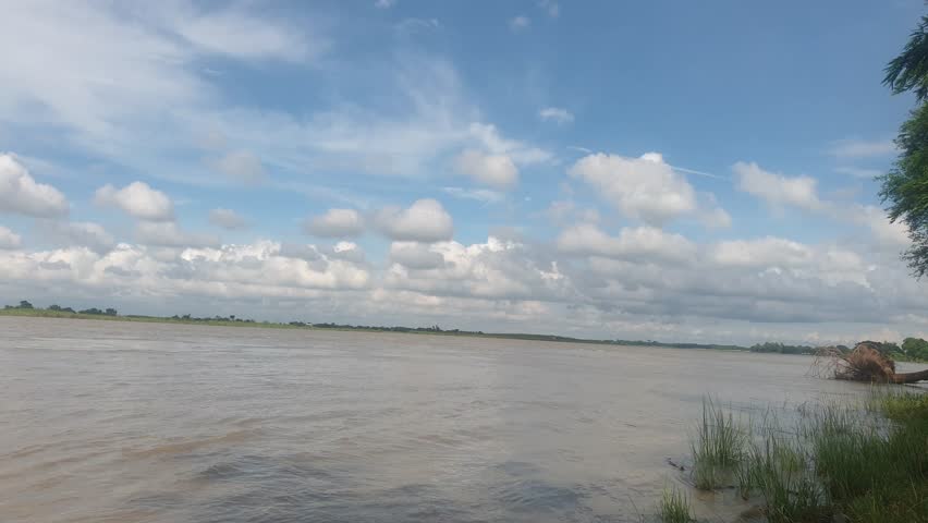 Peaceful River Landscape Under Blue Sky with White Clouds – Natural Scenery Background