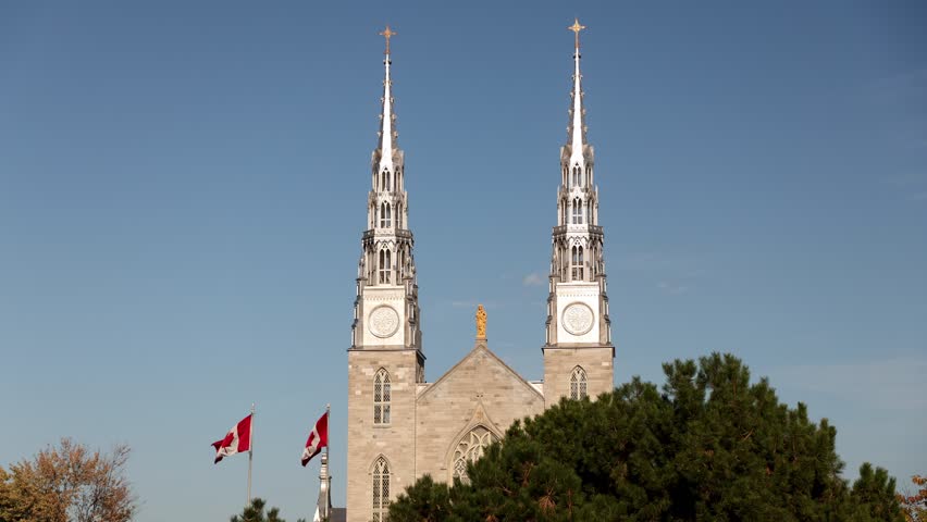 Notre-Dame Cathedral Basilica in Ottawa, Canada. Landmark church in downtown with Canadian flags
