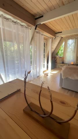 Cozy A-Frame Cabin Interior with Stone Fireplace, Sheepskin Throw, and Soft Natural Light Through Sheer Curtains, Warm Scandinavian Rustic Living Room Design in Mountain Retreat Setting