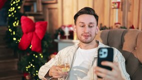 Smiling man enjoys cheerful Christmas video call. Shares happy moments with distant loved ones. Festive mood, cozy home ambiance brings joyful holiday connection. - Powered by Shutterstock - Get 15% off with code: PIKWIZARD15