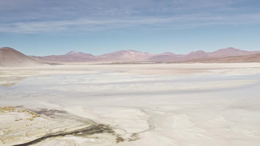 Aerial view of a salt flat and surrounding mountains in the Atacama Desert, Chile