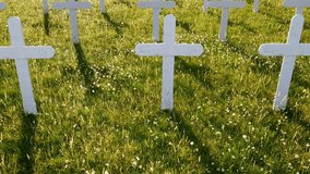 Eerie cinematic pan over a graveyard with unmarked white crosses, creating a solemn, haunting, and reflective atmosphere in slow motion. - Powered by Shutterstock - Get 15% off with code: PIKWIZARD15