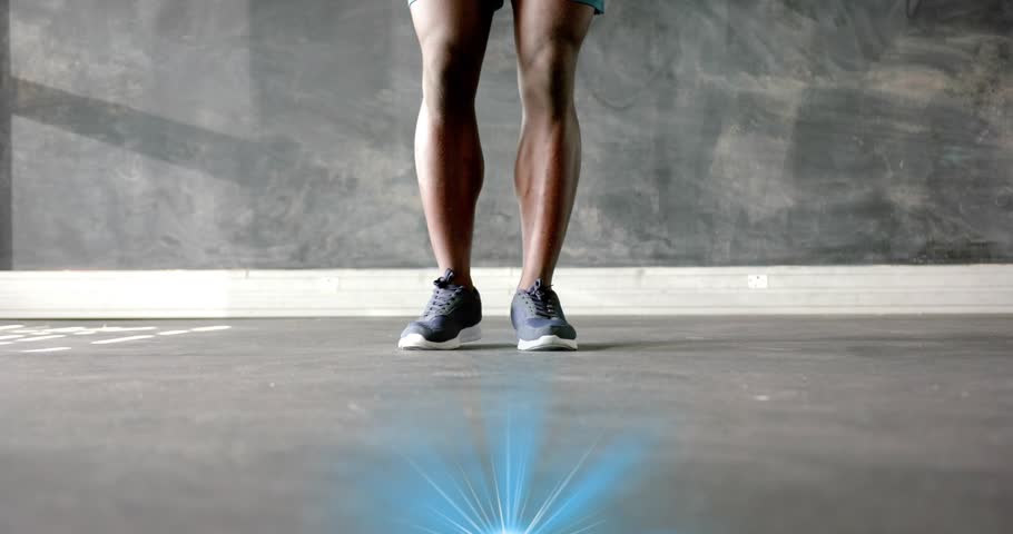 Man swinging jump rope and shifting weight hopping rhythmically with pulsing blue glow for fitness. Cardio, fitness, athletic, exercise, motion, dynamic, modern