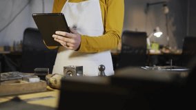 Female artisan tapping tablet in tech workshop and growing translucent network overlay mapping data. Craftsman, innovation, technology, collaboration, crafts, contemporary, connectivity - Powered by Shutterstock - Get 15% off with code: PIKWIZARD15