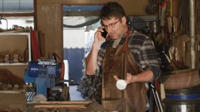 Woodworker receiving phone call and monitoring animated user icons linking woodworking network. Craftsman, digital connectivity, innovative, craftsmanship, workshop, technical, networking - Powered by Shutterstock - Get 15% off with code: PIKWIZARD15