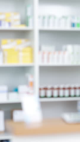 Pharmacy, blurry and tablets in drug store, medicine and supplements with shelves. Empty, stock and inventory with wellness, healthcare and service with pharmaceuticals, retail and medical products