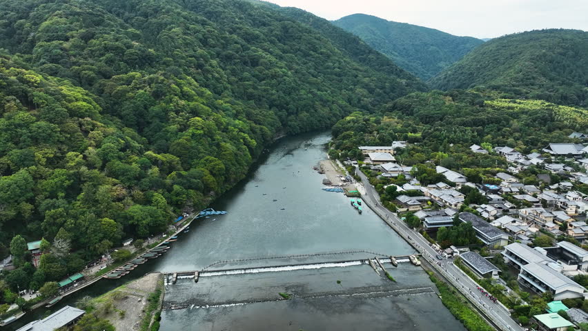 Ōi River (Katsura River) With Lush Forest Mountain In Arashiyama District In Kyoto, Japan. Aerial Drone Shot