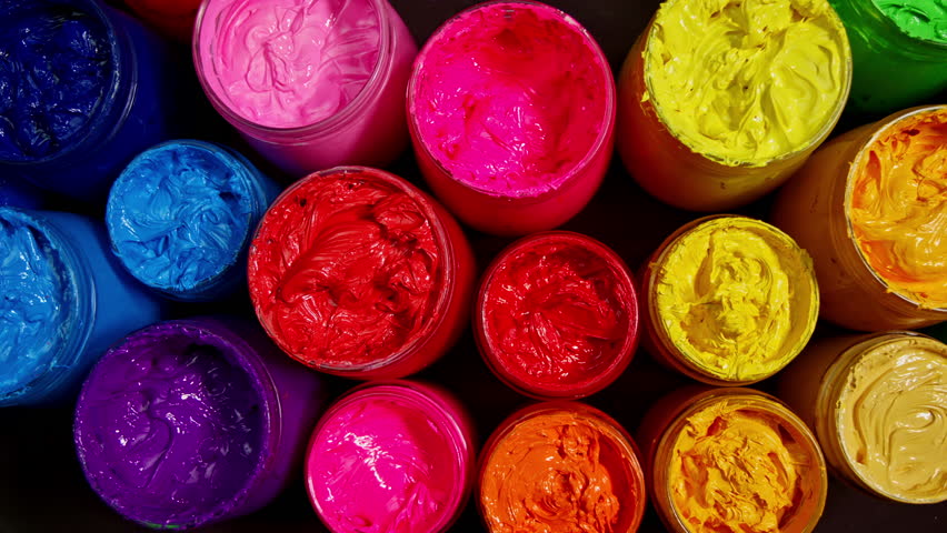 An inspiring display of colorful paint jars that capture the essence of art and creativity through their bold tones and harmonious arrangement.