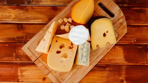 different cheeses served on wooding cutting board 1920x1080 intro motion slow hidef hd