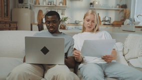Portrait of students in room, black man and blonde lady with papers and laptop. Interracial loving couple planning finances and family budget, african american male person and caucasian woman at home - Powered by Shutterstock - Get 15% off with code: PIKWIZARD15