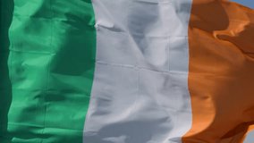 Close-up of Irish flag rippling in bright daylight, vibrant colors, gentle wind movement, static camera - Powered by Shutterstock - Get 15% off with code: PIKWIZARD15